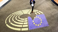 A man walks inside the European Parliament.