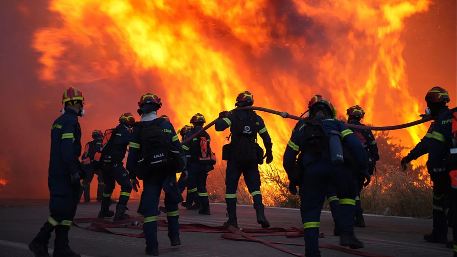 Firefighters battling a wildfire in Greece