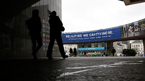 A woman walks past the European Parliament in Brussels on Tuesday 27 May 2025. 