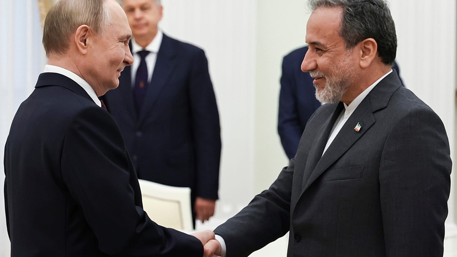 Vladimir Putin, à esquerda, cumprimenta o ministro dos Negócios Estrangeiros iraniano, Abbas Araghchi, antes das suas conversações no Kremlin em Moscovo,23 junho 2025