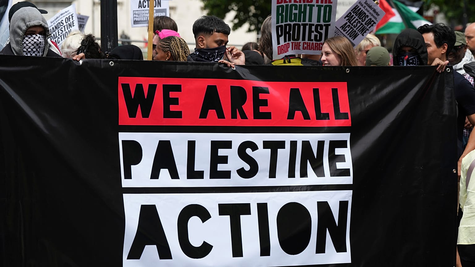 Dimostranti reggono uno striscione durante una protesta del gruppo Palestine Action a Londra, lunedì 23 giugno 2025.