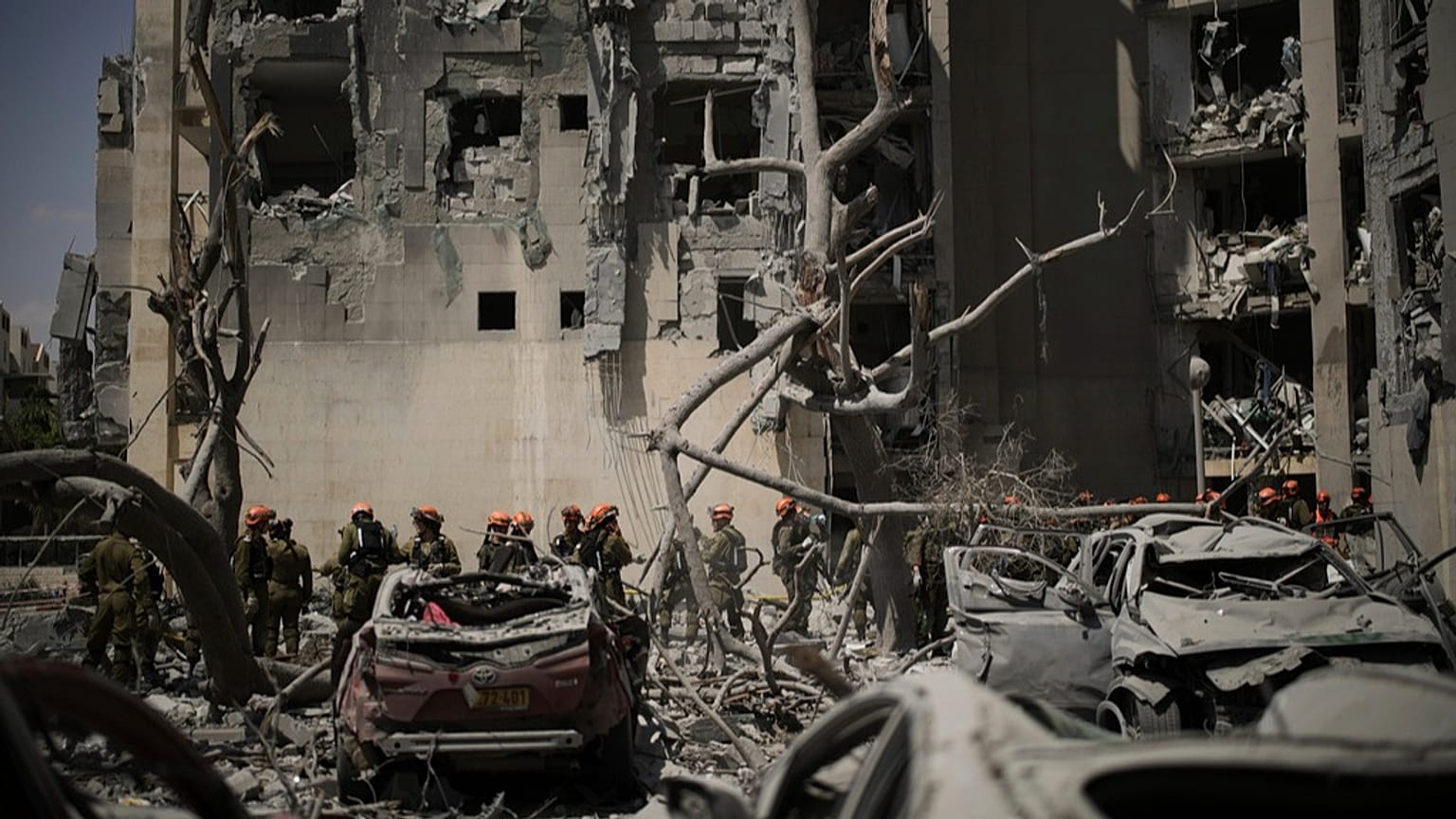 Israeli soldiers from the Home Front Command unit work at the site struck by an Iranian missile strike that killed several people, in Beersheba, Israel, on Tuesday, June 24.