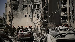 Israeli soldiers from the Home Front Command unit work at the site struck by an Iranian missile strike that killed several people, in Beersheba, Israel, on Tuesday, June 24.