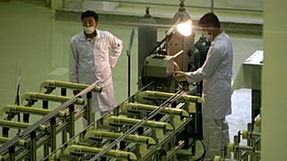 FILE: Iranian technicians work at a new facility producing uranium fuel for a planned heavy-water nuclear reactor, just outside the city of Isfahan, 9 April 2009