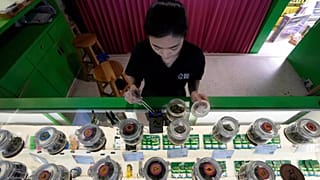 A staff prepares flower bud of cannabis for a customer at cannabis shop in Bangkok, Thailand, July 18, 2024.
