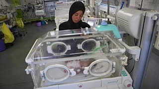 Seham Fawzy Khodeir watches her son in an incubator at the neonatal intensive care unit of Nasser Hospital in the Gaza Strip on June 19, 2025.