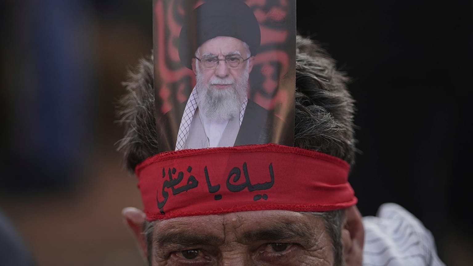 أحد أنصار حزب الله يرتدي عصابة رأس كُتب عليها باللغة العربية: "لبيك يا خامنئي"، لبنان، الأربعاء 25 يونيو/حزيران 2025.  