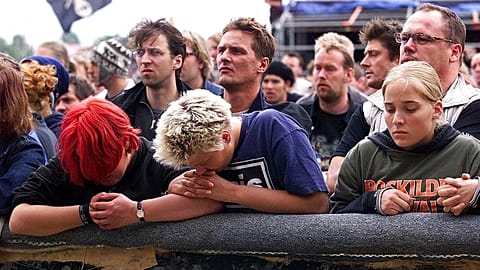 Young people grieve and pray during a memorial service held by the bishop of Roskilde, Jan Lindhardt, Saturday, July 1, 2000