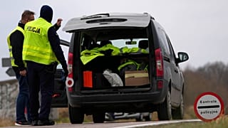 FILE: Polish police officers patrol vehicles, near the Polish-Belarusian border, 15 November 2021