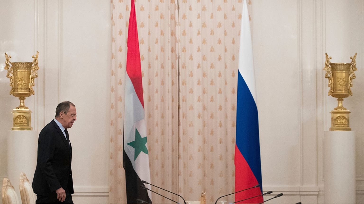 وزیر امور خارجه روسیه در کنار پرچم روسیه و پرچم سوریه در زمان دولت بشار اسد