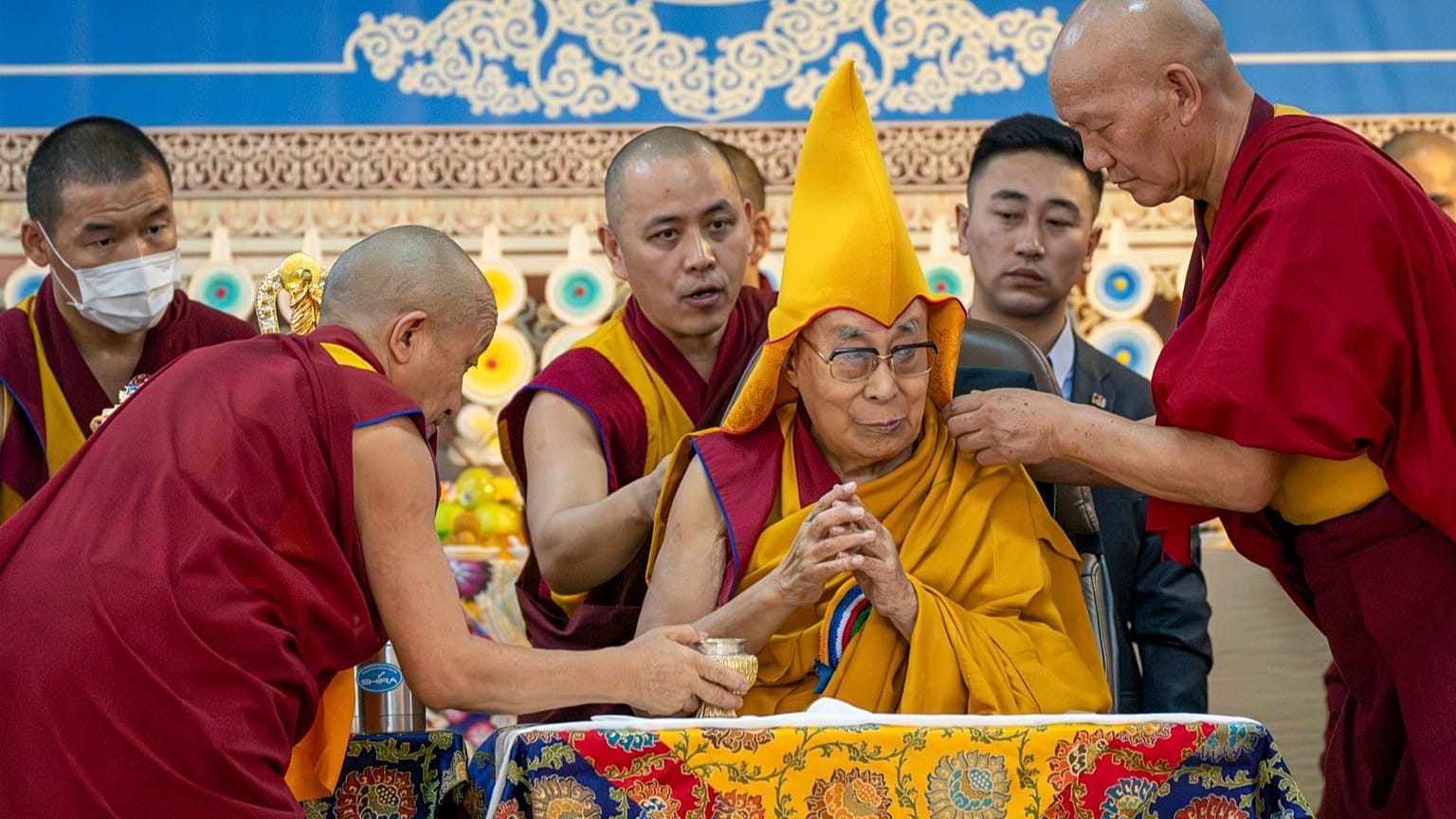 ARQUIVO: Monges ajudam o Dalai Lama enquanto ele preside à celebração do seu 90º aniversário no templo Tsuglakhang em Dharamshala, Índia, 30 de junho de 2025