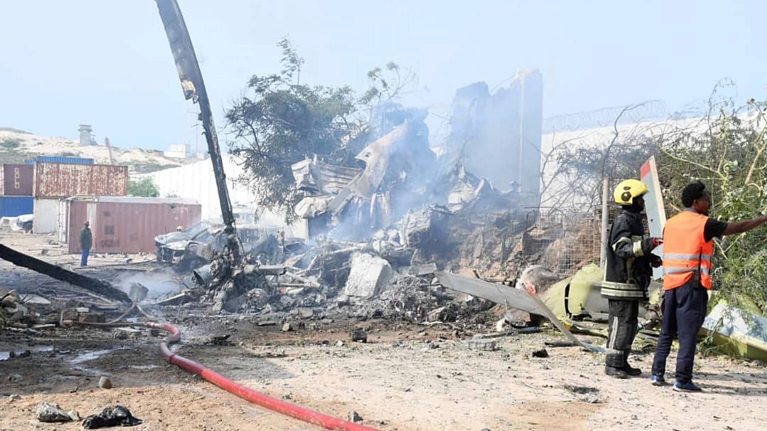 Rescue efforts take place at the site after an African Union military helicopter crashed at Aden Adde airport in Mogadishu, 2 July, 2025