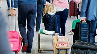 Um menino é puxado numa mala quando o sindicato alemão Ver.di entrou em greve de alerta nos aeroportos alemães em Frankfurt, Alemanha, quarta-feira, 27 de abril de 2016