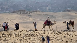 سياح يتجولون في موقع أهرامات الجيزة التاريخي، على مشارف القاهرة، مصر،