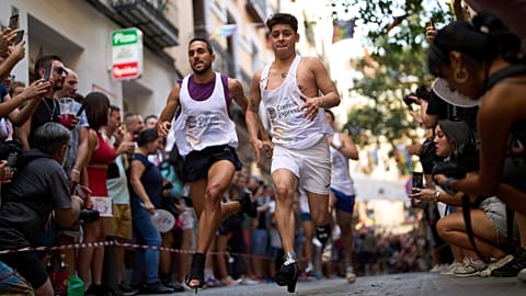 Participants wearing shoes with heels of at least 15 centimeters (5.9 inches) compete in the annual high heel race during Madrid's Pride week, in Madrid, Spain, July 3, 2025.