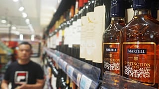 Bottles of brandy are seen on a shelf at a supermarket in Hangzhou in eastern China's Zhejiang province, 8 October, 2024