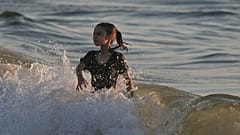 Ein palästinensisches Mädchen kühlt sich während einer Hitzewelle am Mittwoch, dem 2. Juli 2025, im Mittelmeer bei Gaza-Stadt ab.
