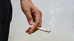 A person holds a cigarette.