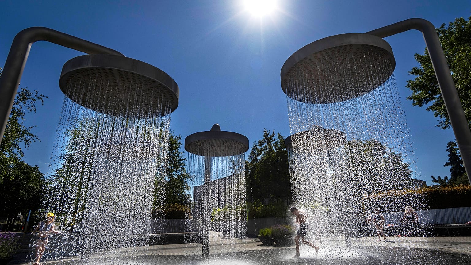 Children cool off on a hot day in a public fountain in Vilnius, 3 July, 2025