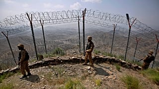 Pakistan Army troops patrol along the fence on the Pakistan-Afghanistan border at Big Ben hilltop post in Khyber district, 3 August, 2021