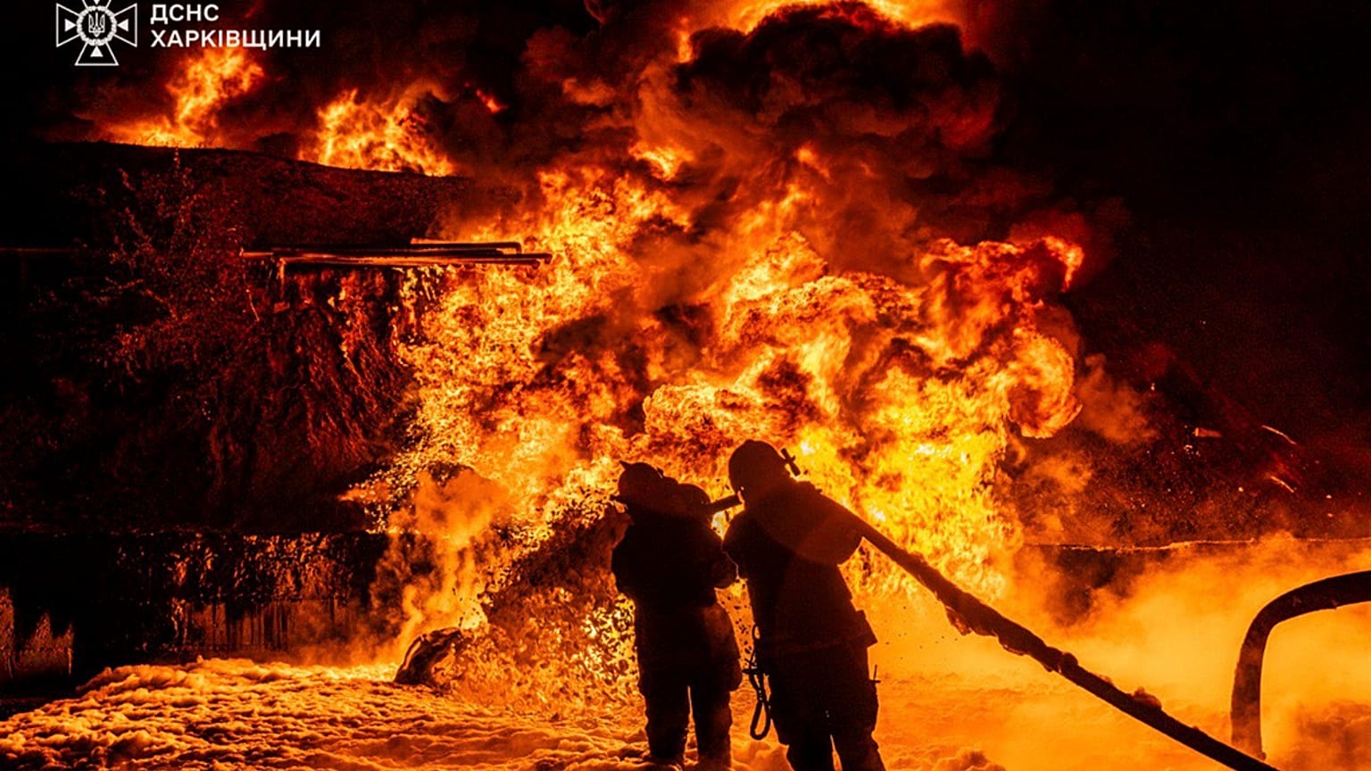 In this photo provided by the Ukrainian Emergency Service, emergency services personnel work to extinguish a fire following a Russian attack in Kharkiv region, Ukraine, Saturd