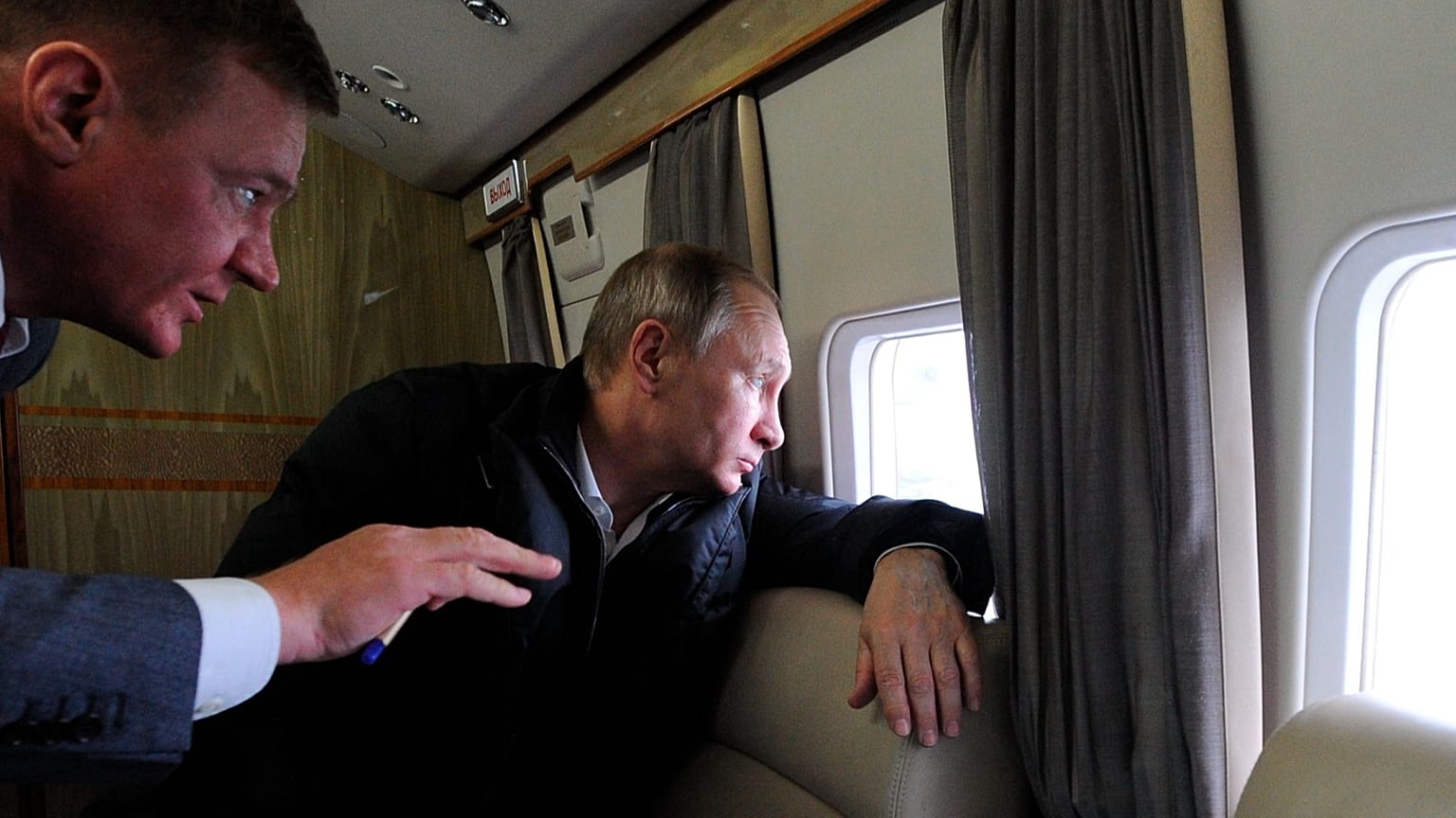 FILE: Russian President Vladimir Putin and Transport Minister Roman Starovoit look out of a helicopter while flying over the site of the Kerch bridge in Crimea, 18 March 2016