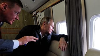 FILE: Russian President Vladimir Putin and Transport Minister Roman Starovoit look out of a helicopter while flying over the site of the Kerch bridge in Crimea, 18 March 2016