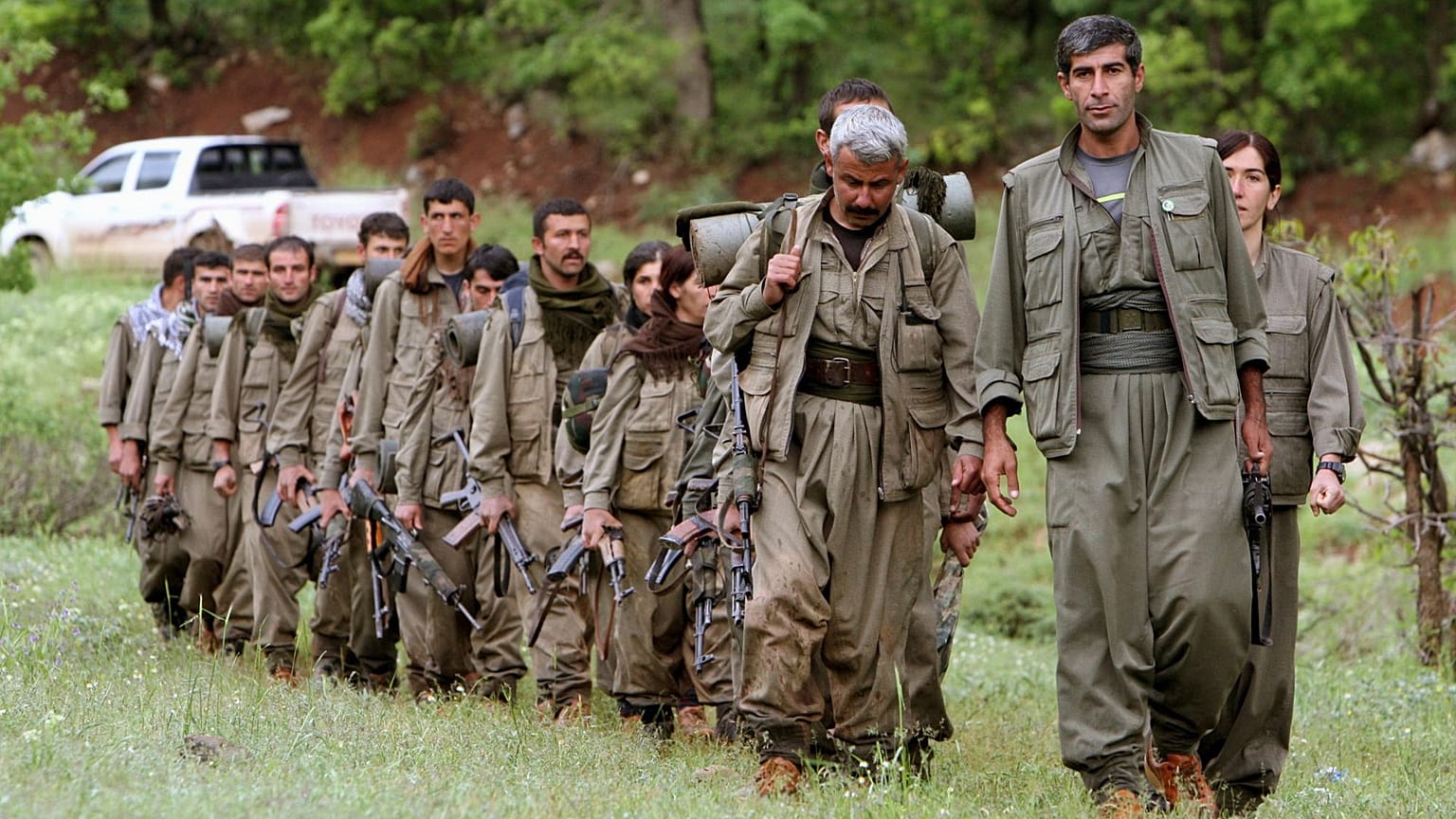 FILE - A group of armed Kurdish fighters from the Kurdistan Workers Party (PKK) enter northern Iraq, 14 May 2013.