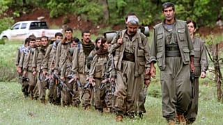 FILE - A group of armed Kurdish fighters from the Kurdistan Workers Party (PKK) enter northern Iraq, 14 May 2013.