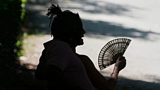 A person rests in the Retiro park in Madrid, 28 June, the city estimated to have suffered the highest proportion of climate-related deaths in the rapid study,