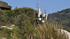 Telecom equipment are seen on top of a hill.