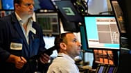 Traders work on the floor at the New York Stock Exchange in New York,