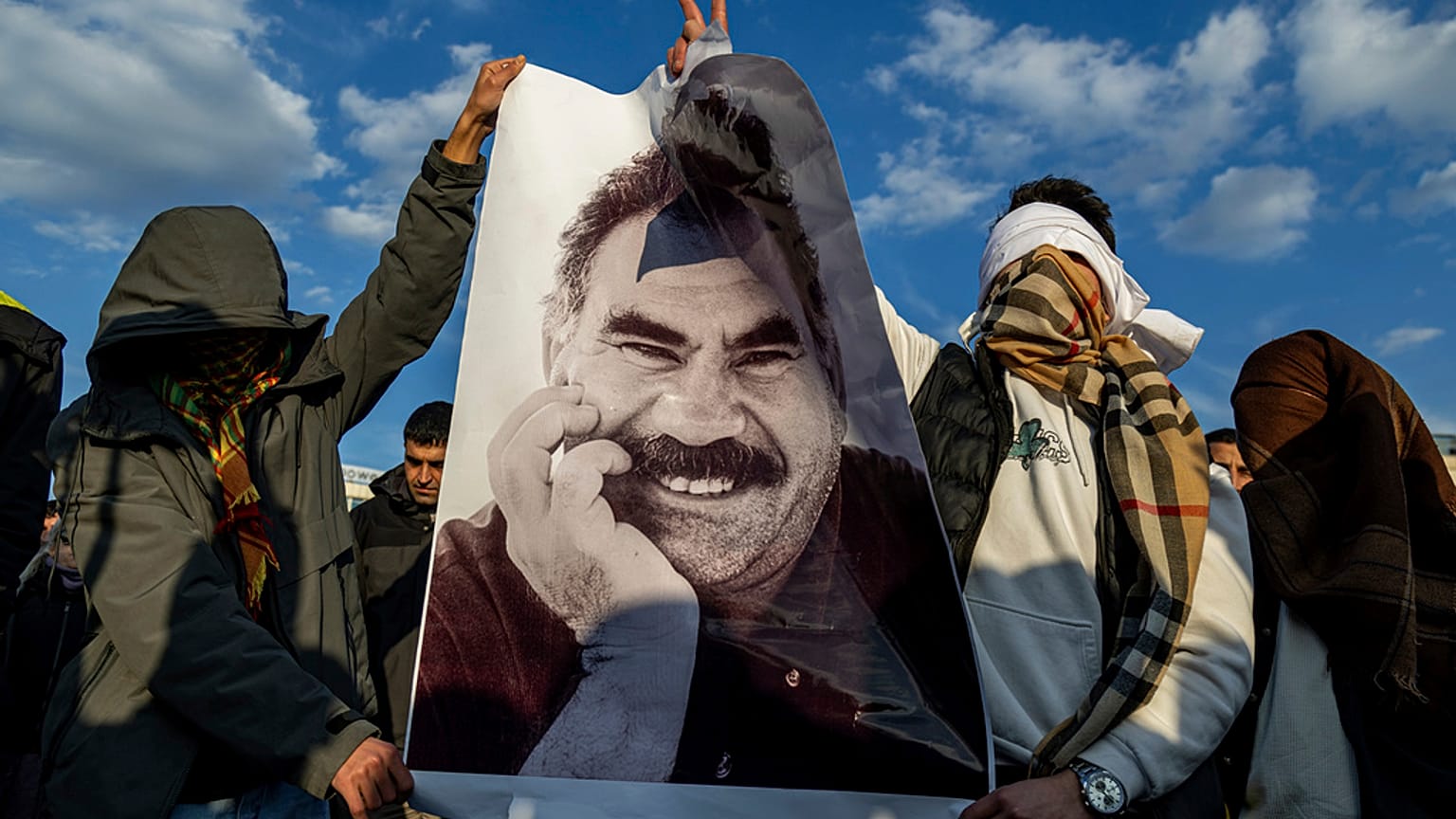 FILE - Youngsters hold a photograph of Abdullah Ocalan, the jailed leader of the militant Kurdish group, or PKK, in Diyarbakir, Turkey, Feb. 27, 2025