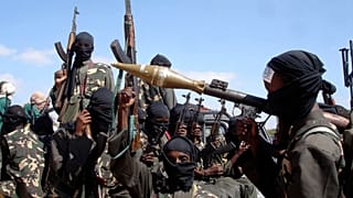 Armed al-Shabab fighters ride on pickup trucks as they prepare to travel into Mogadishu, 8 December, 2008