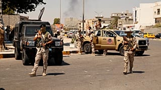 Libyan army forces and vehicles are stationed in a street in the country’s capital of Tripoli, 22 July 2022