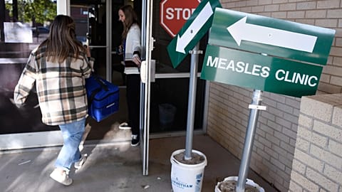 Health workers enter a measles clinic in Texas on April 8, 2025.
