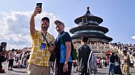Tourists take a selfie at the Temple of Heaven in Beijing on June 15, 2025. 