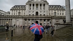  Şemsiyeli bir kadın Londra'daki finans bölgesinde, İngiltere Merkez Bankası'nın önünde duruyor. 3 Kasım 2022.