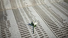 Eine Blume steht auf einem Denkmal mit den Namen der Opfer des Völkermords von Srebrenica im Memorial Center in Potocari, Bosnien, Freitag, 11. Juli 2025