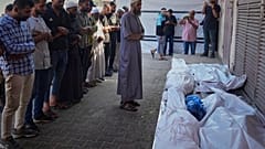 فلسطينيون يصلون على جثث 10 أشخاص، بينهم امرأتان وخمسة أطفال، قتلوا في غارة إسرائيلية أثناء انتظارهم لتلقي المكملات الغذائية في عيادة طبية تديرها مؤسسة "مشروع الأمل" في دير الب