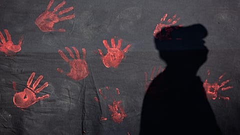 A man casts a shadow on a banner during a demonstration to denounce violence against women in Lisbon, 1 June, 2016