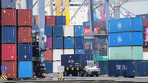 A truck drives past stacks of containers at Jakarta International Container Terminal (JICT) at Tanjung Priok Port in Jakarta, Indonesia, Wednesday, July 9, 2025.