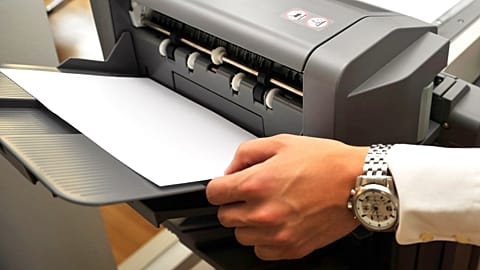 A doctor uses a fax machine.