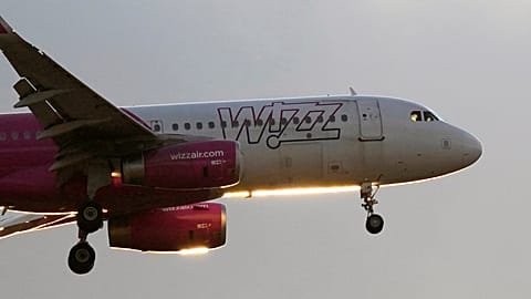 A Wizz Air Airbus A320 approaches for landing at sunset in Lisbon, Portugal. 20 July 2024.