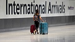 FILE: A passenger arrives from a flight at Terminal 5 of Heathrow Airport in London, 2 August 2021