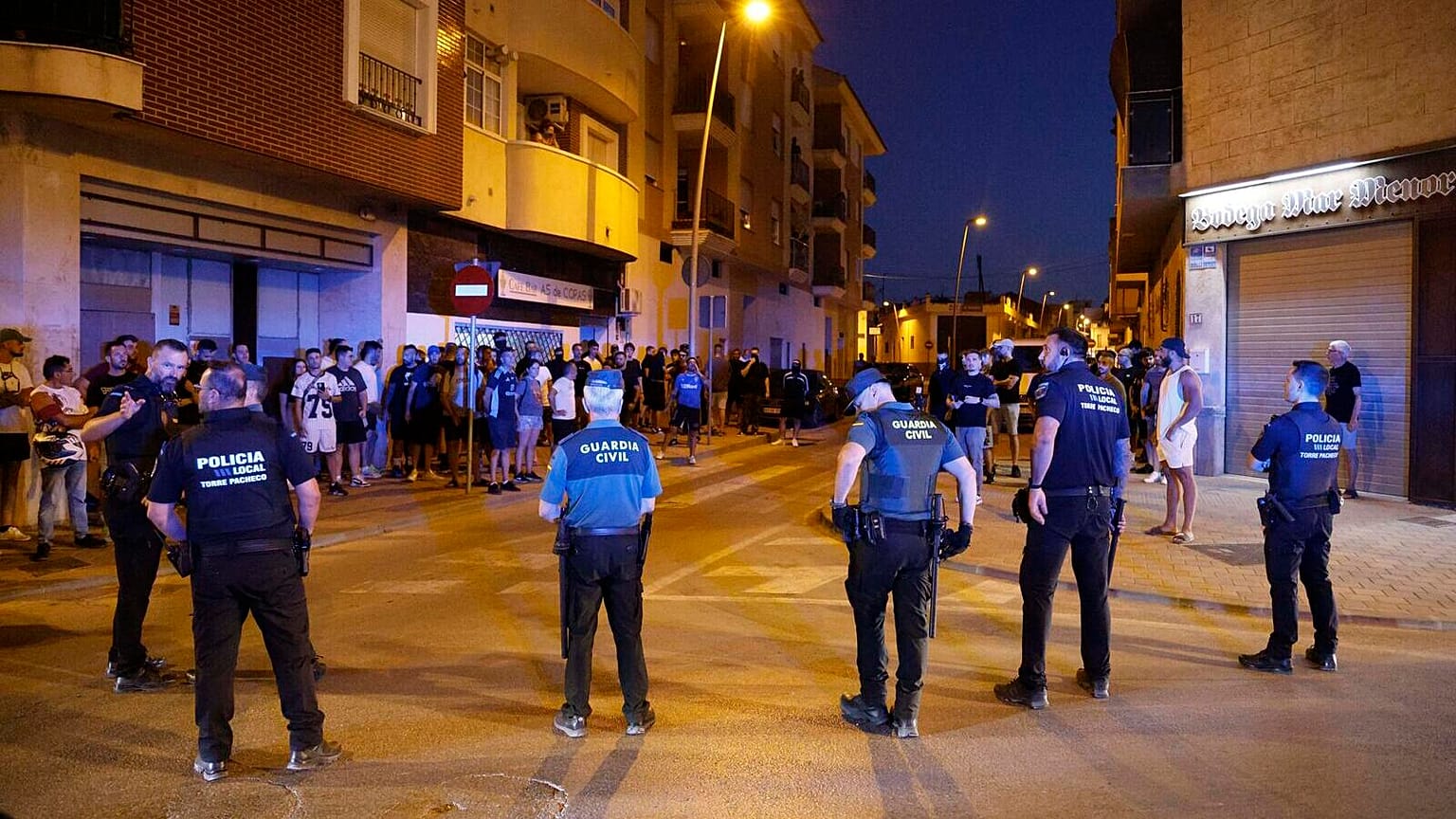 Local police officers and Spanish civil guard agents take positions during the disturbances in Torre Pacheco, eastern Spain, Friday, July 12, 2025