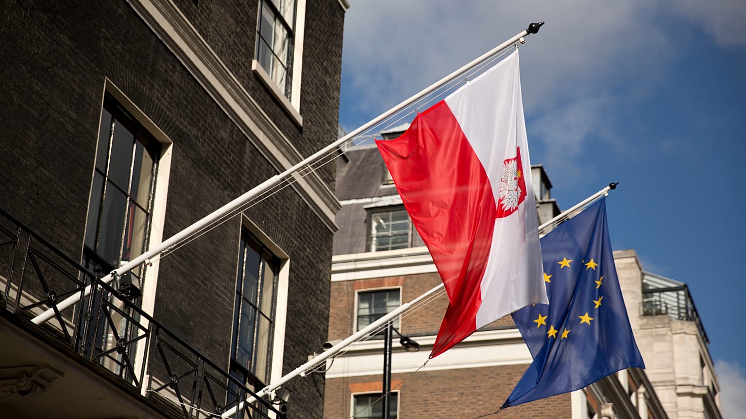 FILE: A Polish and EU flag fly outside the Polish Embassy in London, 27 October 2016
