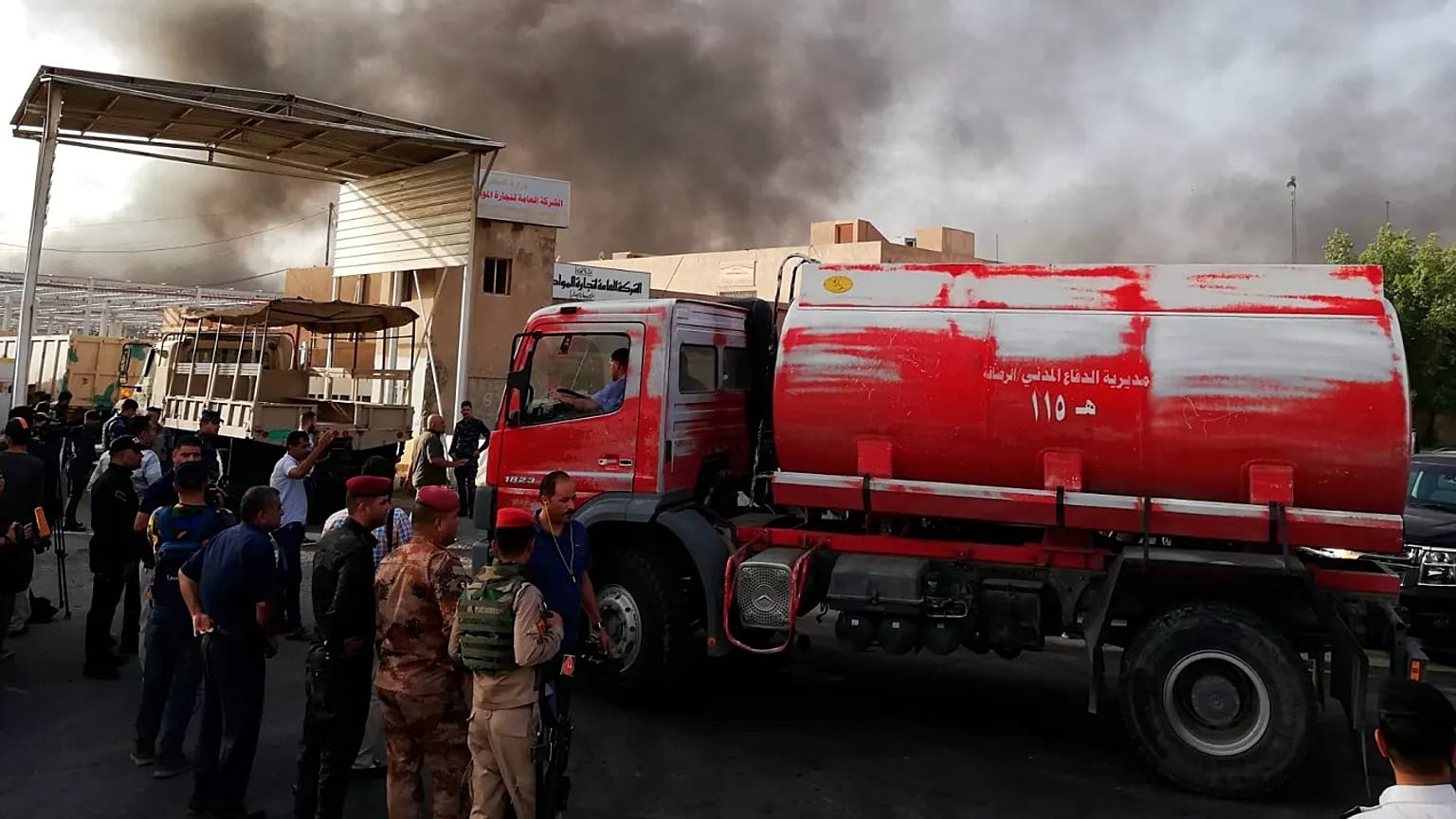 ARCHIVO: Fuerzas de seguridad iraquíes y bomberos se reúnen mientras el humo se eleva de un incendio en Bagdad, 10 de junio de 2018 - Copyright AP Photo