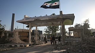 عناصر الأمن يحملون أمتعتهم أثناء مغادرتهم مبنى وزارة الدفاع السورية المتضرر الذي يزعم أنه تعرض لعدة غارات جوية إسرائيلية ، في دمشق ، سوريا ، الأربعاء 16 يوليو / تموز 2025.