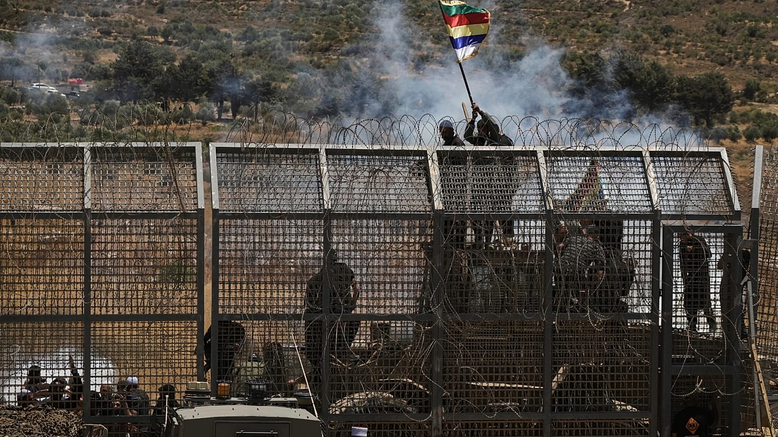 İsrail kontrolündeki Golan Tepeleri'ndeki Majdal Şems kasabasından görüldüğü üzere, İsrail-Suriye sınırına yakın Suriyeli Dürzi protestosu, 16 Temmuz 2025.